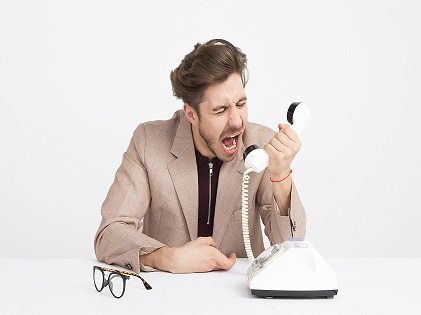 moody angry man holding phone